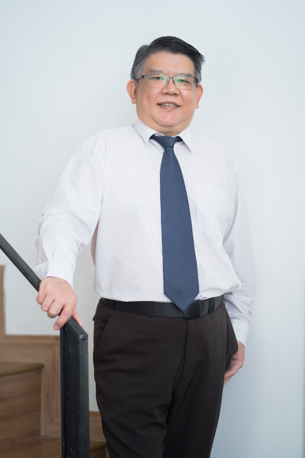 Kelvin Ng Choo Kent standing in professional attire